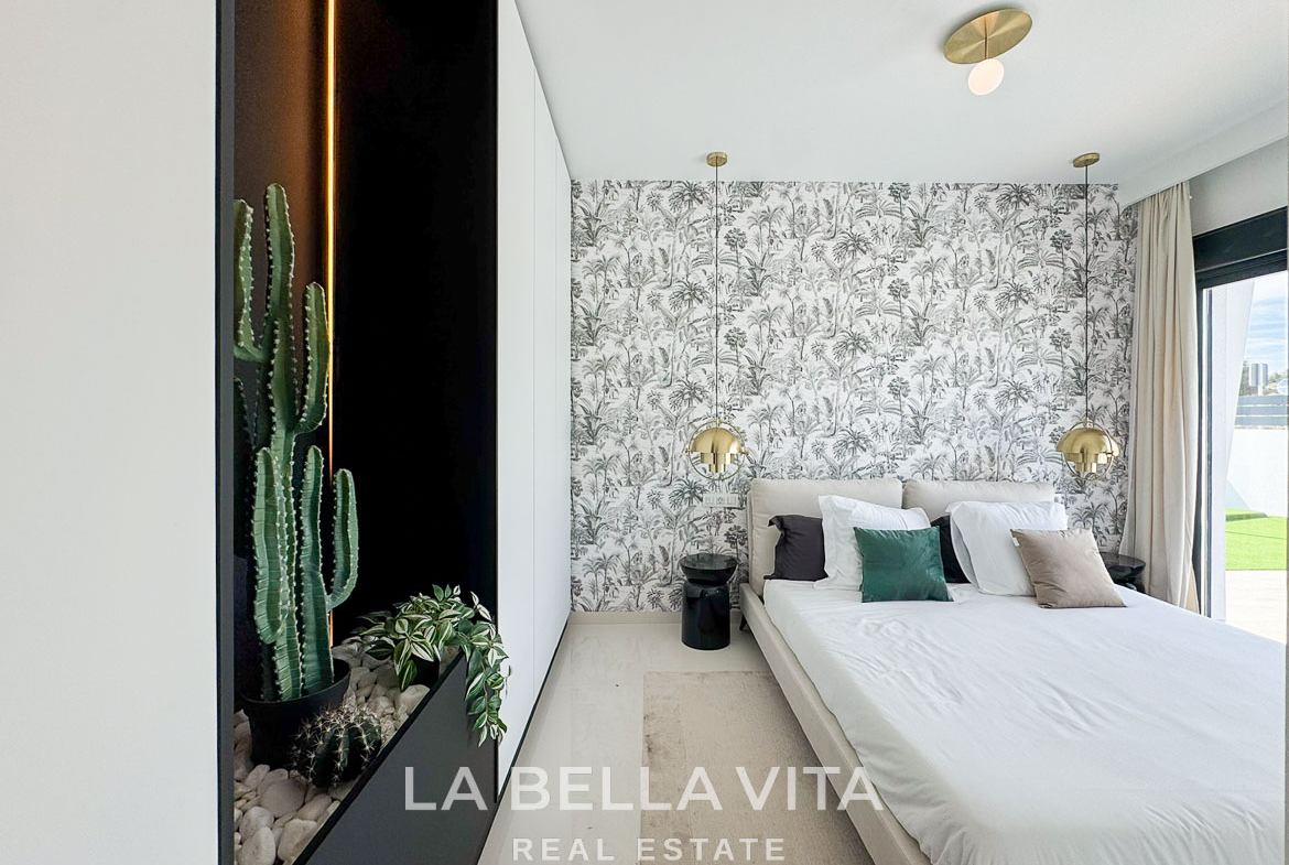 Bright modern bedroom with botanical wallpaper and plush bedding in luxury 3 bedroom villa in San Miguel de Salinas