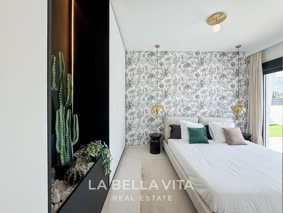 Bright modern bedroom with botanical wallpaper and plush bedding in luxury 3 bedroom villa in San Miguel de Salinas