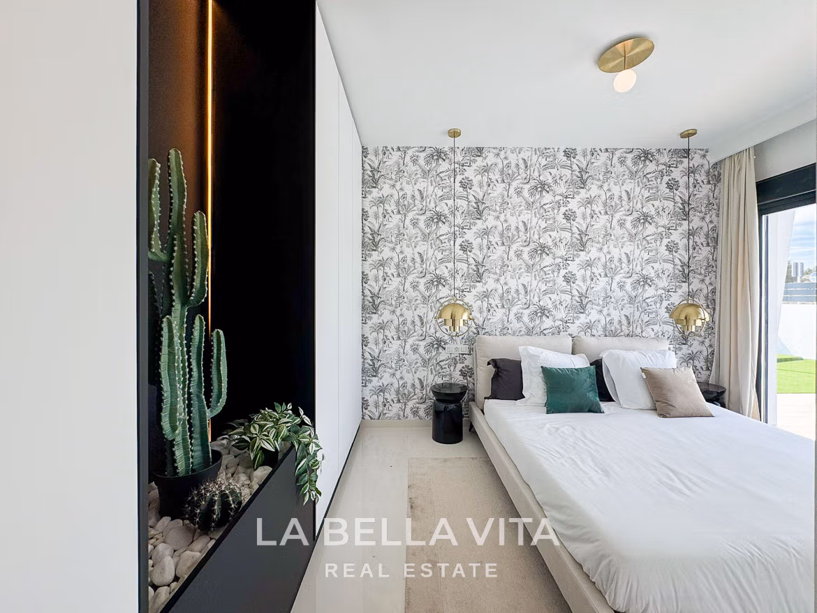 Bright modern bedroom with botanical wallpaper and plush bedding in luxury 3 bedroom villa in San Miguel de Salinas