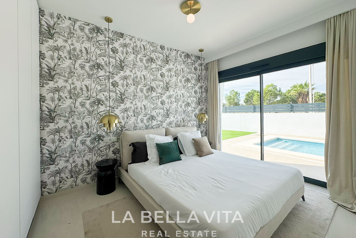 Bright modern bedroom with sliding glass doors overlooking private pool in luxurious 3-bedroom villa San Miguel de Salinas