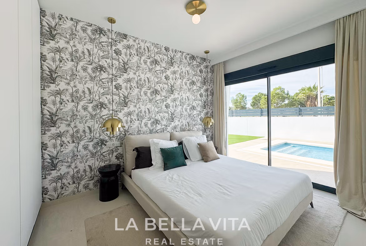Bright modern bedroom with sliding glass doors overlooking private pool in luxurious 3-bedroom villa San Miguel de Salinas