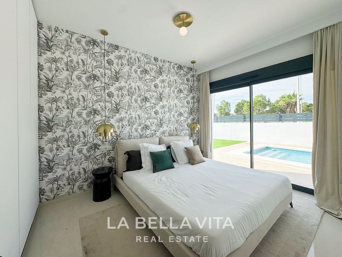 Bright modern bedroom with sliding glass doors overlooking private pool in luxurious 3-bedroom villa San Miguel de Salinas