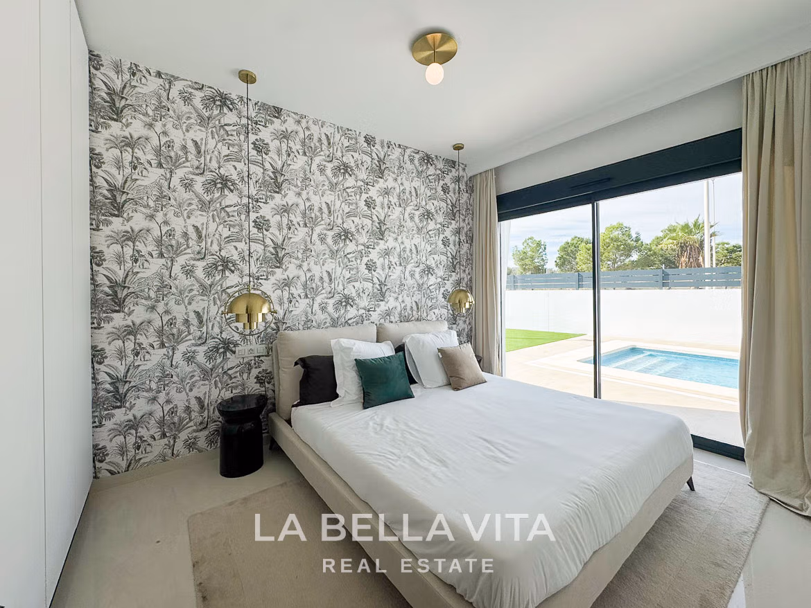 Bright modern bedroom with sliding glass doors overlooking private pool in luxurious 3-bedroom villa San Miguel de Salinas