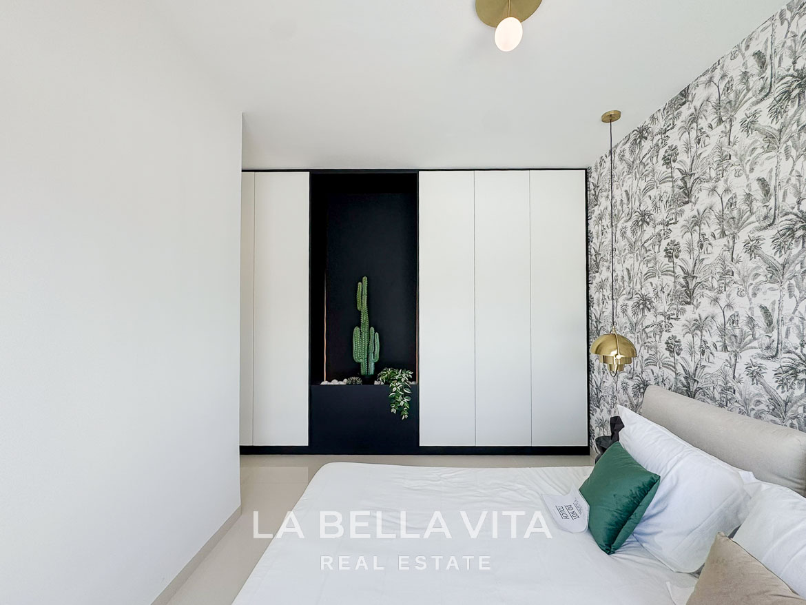 Bright modern bedroom with elegant wallpaper and built-in wardrobes in a sleek 3-bedroom villa in San Miguel de Salinas