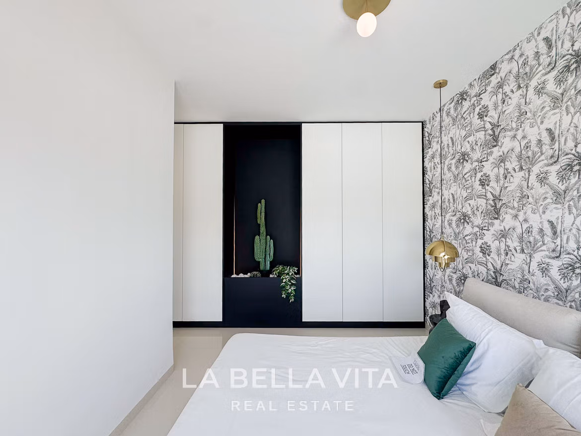 Bright modern bedroom with elegant wallpaper and built-in wardrobes in a sleek 3-bedroom villa in San Miguel de Salinas