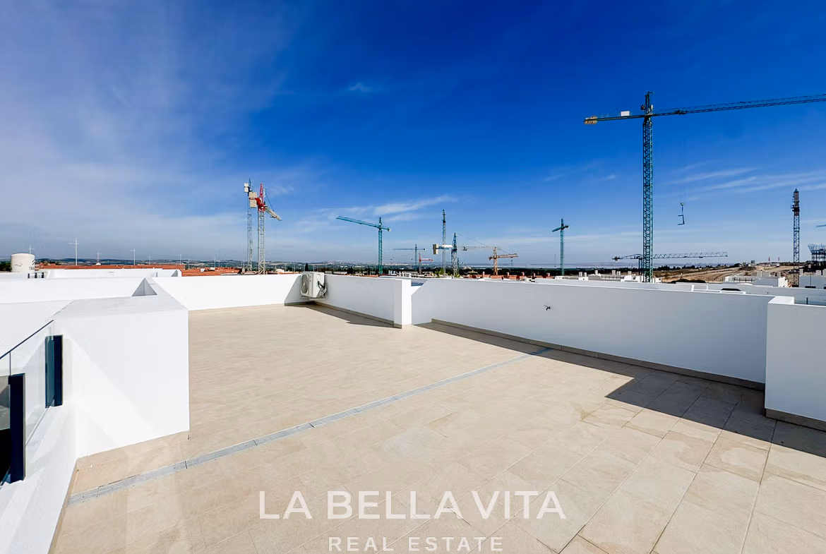 Spacious sun-drenched solarium terrace of modern 3-bedroom villa in San Miguel de Salinas with panoramic skyline views.