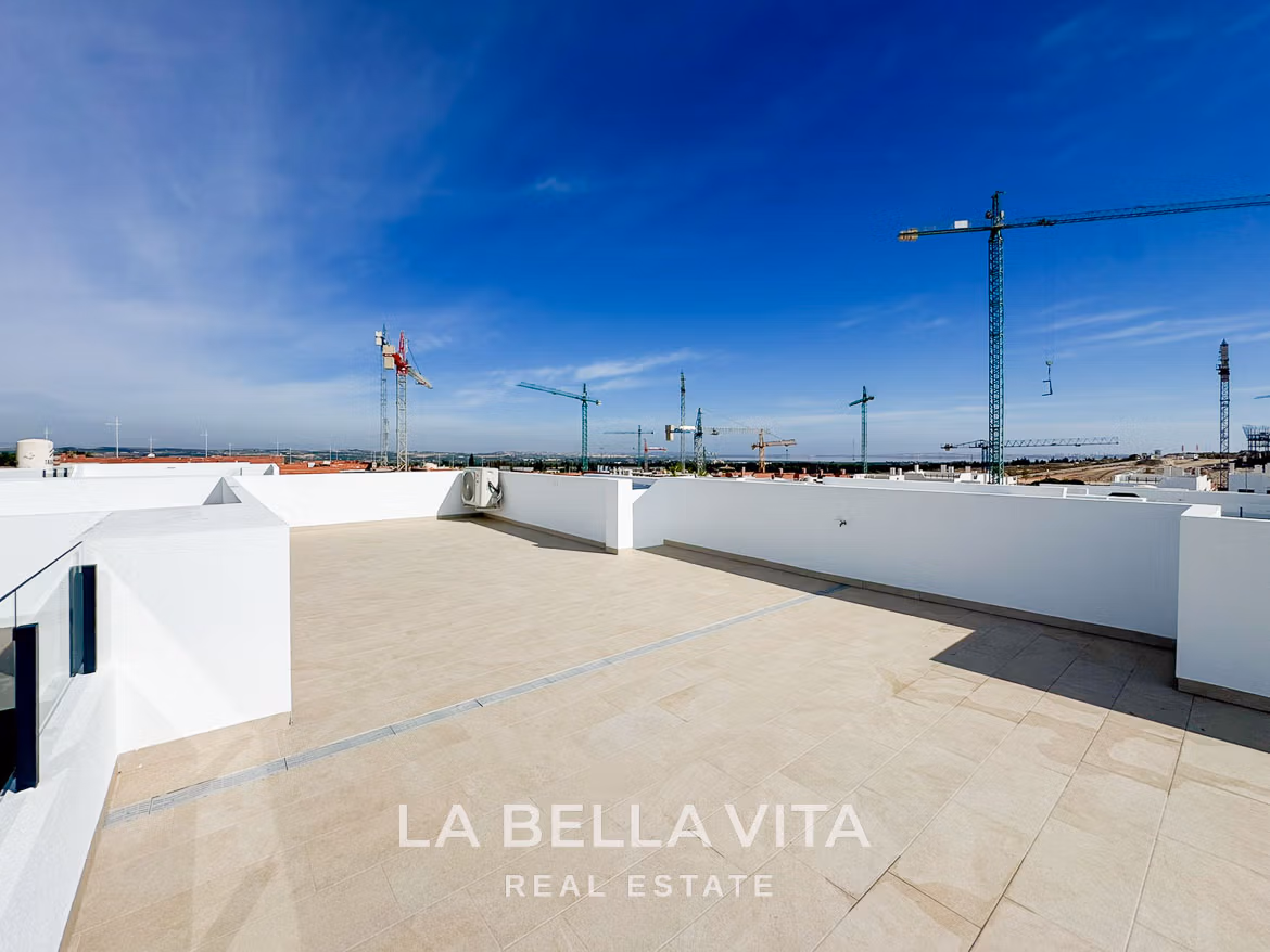Spacious sun-drenched solarium terrace of modern 3-bedroom villa in San Miguel de Salinas with panoramic skyline views.