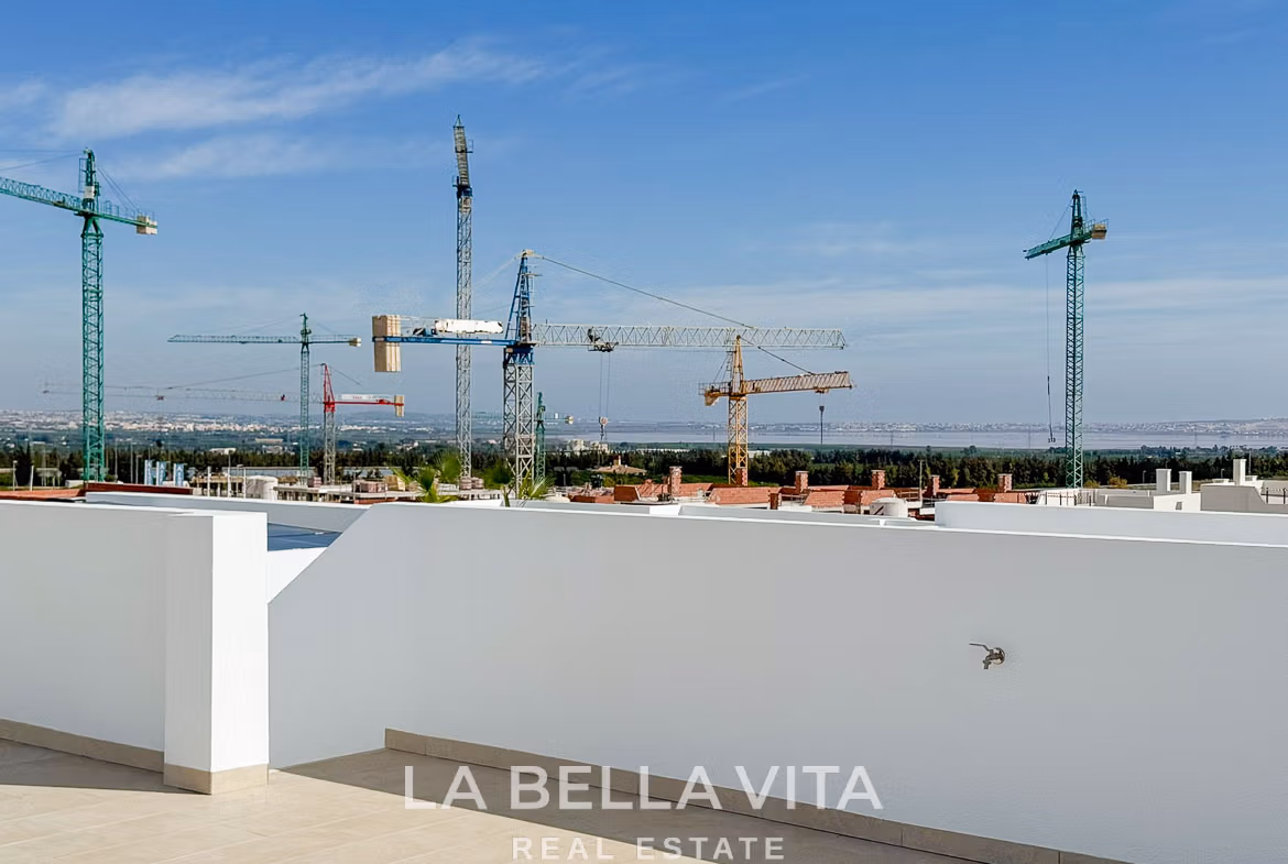 Sun-drenched solarium terrace with panoramic views and modern white walls in luxury 3-bedroom villa in San Miguel de Salinas