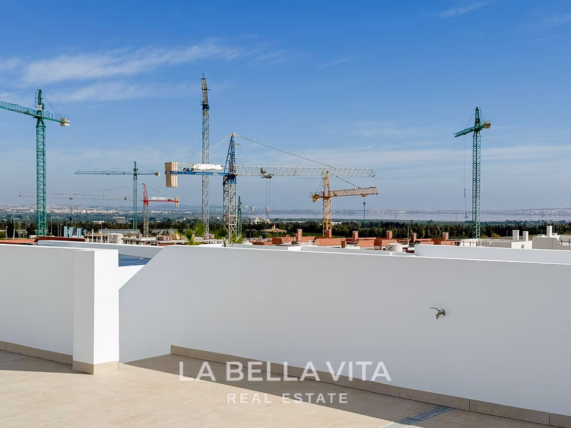 Sun-drenched solarium terrace with panoramic views and modern white walls in luxury 3-bedroom villa in San Miguel de Salinas
