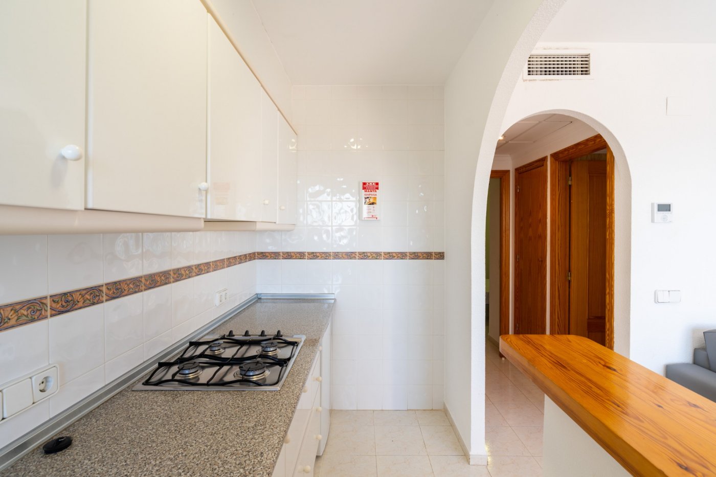 Bright, modern kitchen with granite countertops and sleek cabinetry in a top floor bungalow apartment in Calpe.
