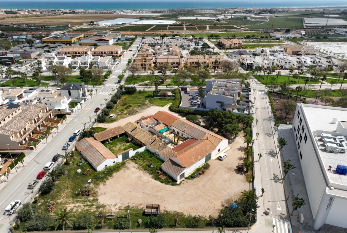 Panoramic aerial view of a bright, modern residential neighborhood in Pilar de la Horadada, Costa Blanca with coastal views.