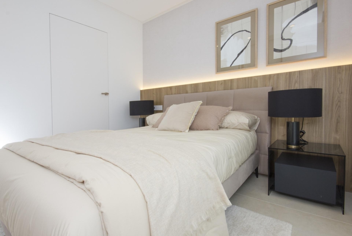 Bright and serene bedroom in a bespoke new build 3-bedroom villa in Ciudad Quesada, featuring elegant wooden accents and...
