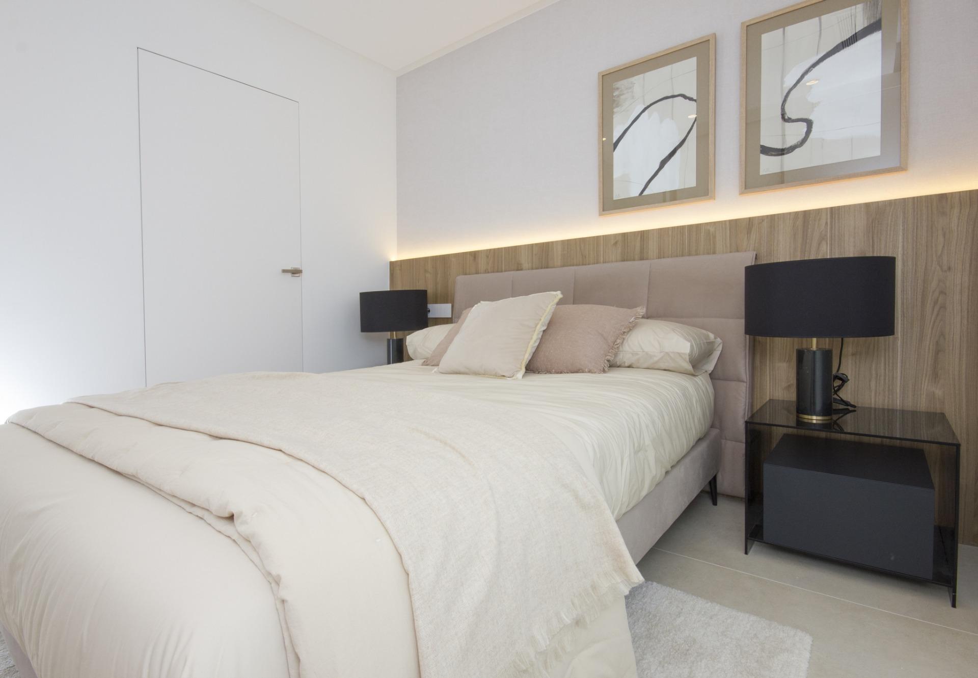 Bright and serene bedroom in a bespoke new build 3-bedroom villa in Ciudad Quesada, featuring elegant wooden accents and...