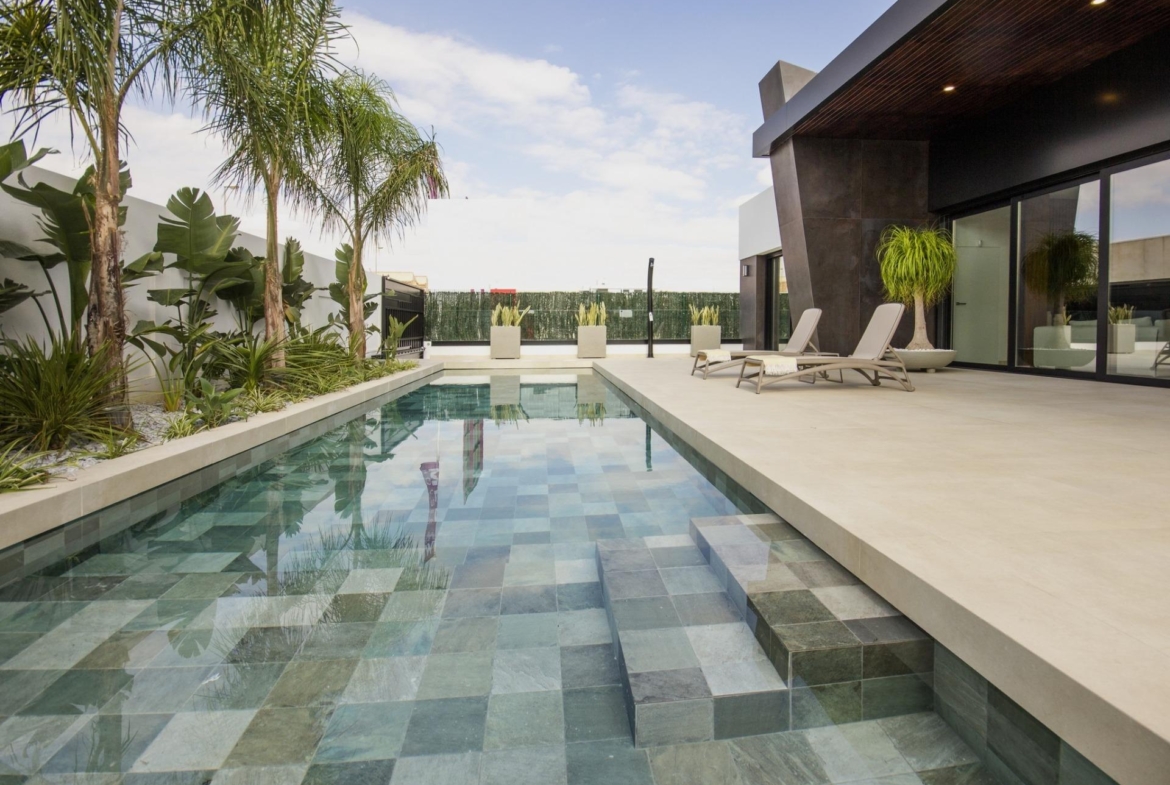 Luxurious bespoke 3-bedroom villa in Ciudad Quesada featuring a sleek private pool, tropical plants, and a spacious...