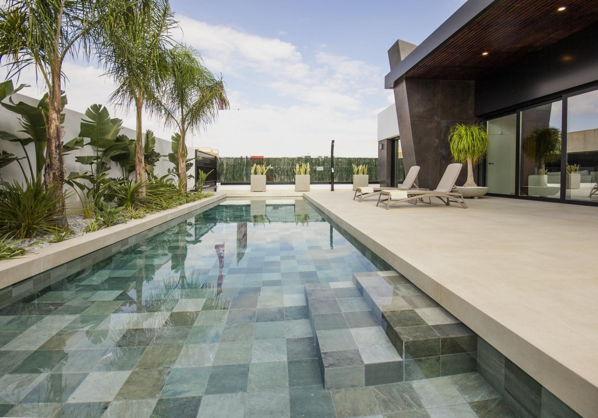 Luxurious bespoke 3-bedroom villa in Ciudad Quesada featuring a sleek private pool, tropical plants, and a spacious...