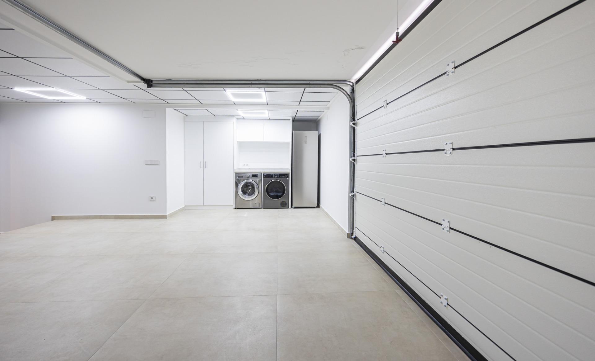 Spacious, sleek garage and laundry room with modern appliances and bright white walls in bespoke Ciudad Quesada villa.
