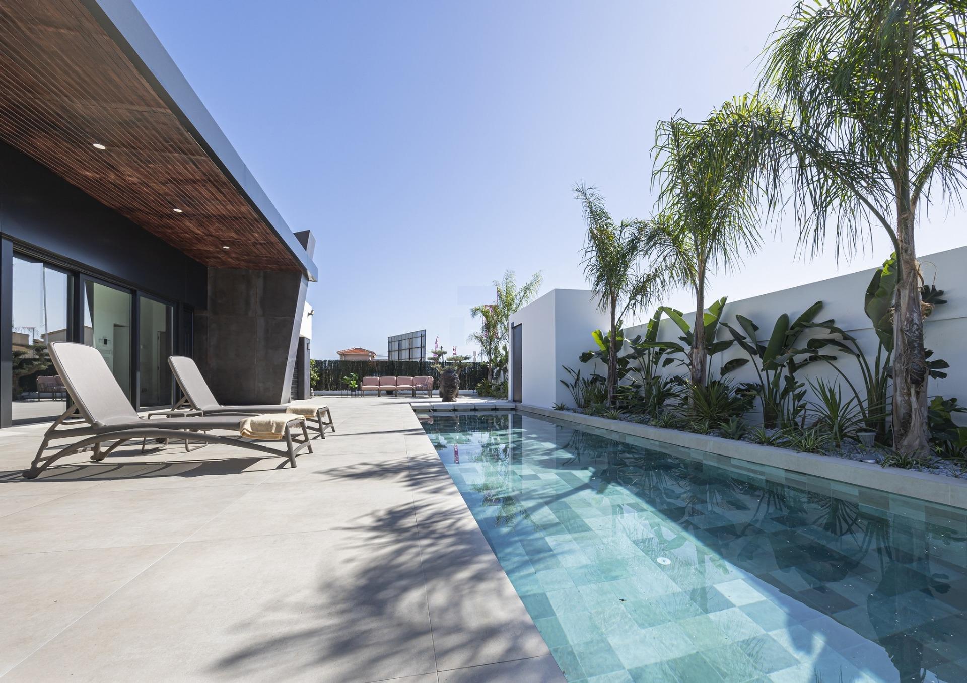 Sun-drenched modern 3-bedroom villa in Ciudad Quesada with sleek outdoor pool, palm trees, and spacious tiled terrace...