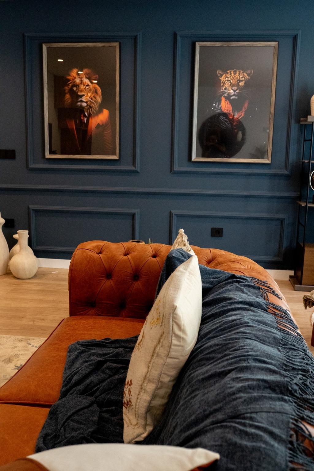 Luxurious living room in bespoke Ciudad Quesada villa with rich navy blue walls, elegant leather sofa, and striking...
