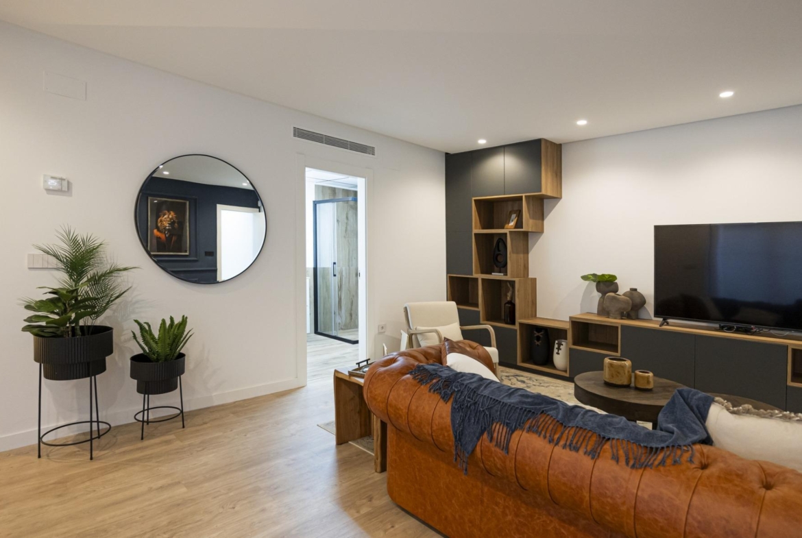 Spacious modern living room in bespoke 3-bedroom villa in Ciudad Quesada with sleek wood flooring and stylish built-in...