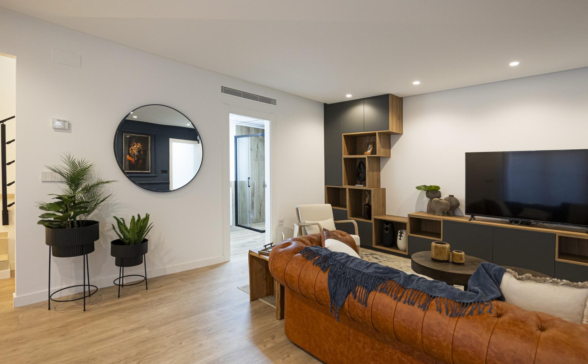 Spacious modern living room in bespoke 3-bedroom villa in Ciudad Quesada with sleek wood flooring and stylish built-in...