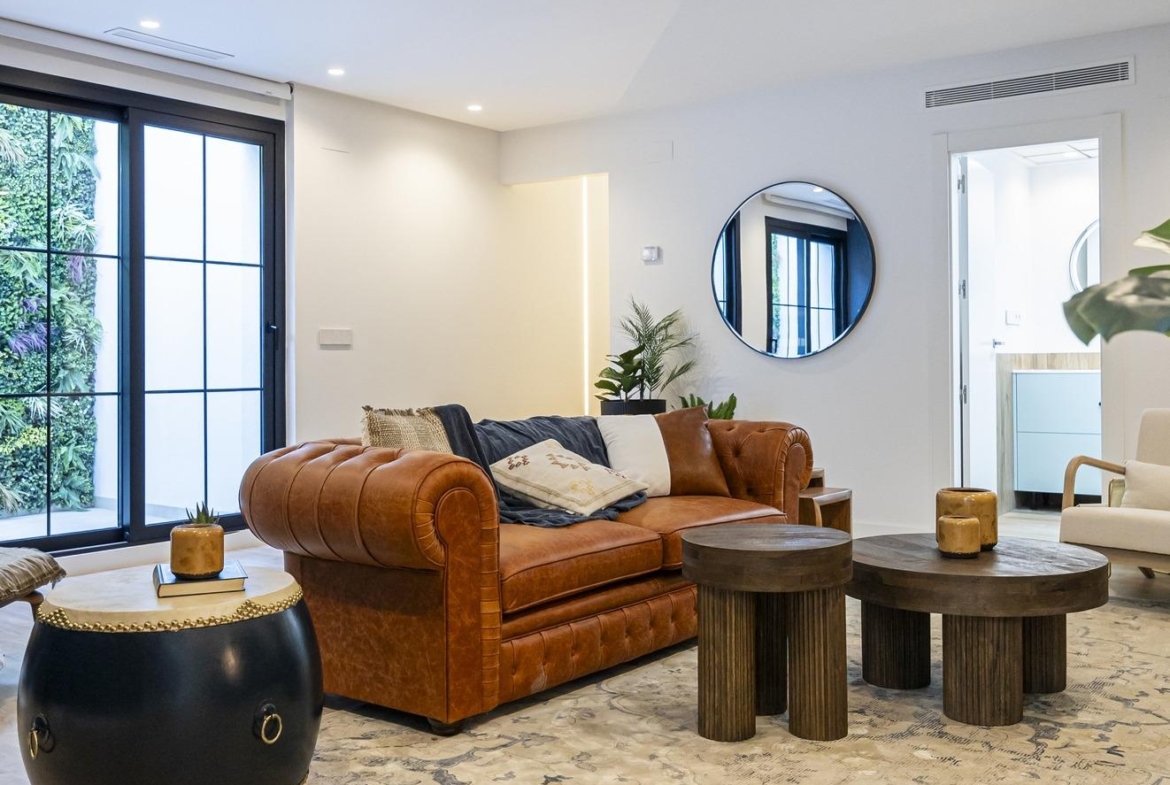 Spacious, bright living room in bespoke 3-bedroom villa in Ciudad Quesada with elegant leather sofa and modern rustic...