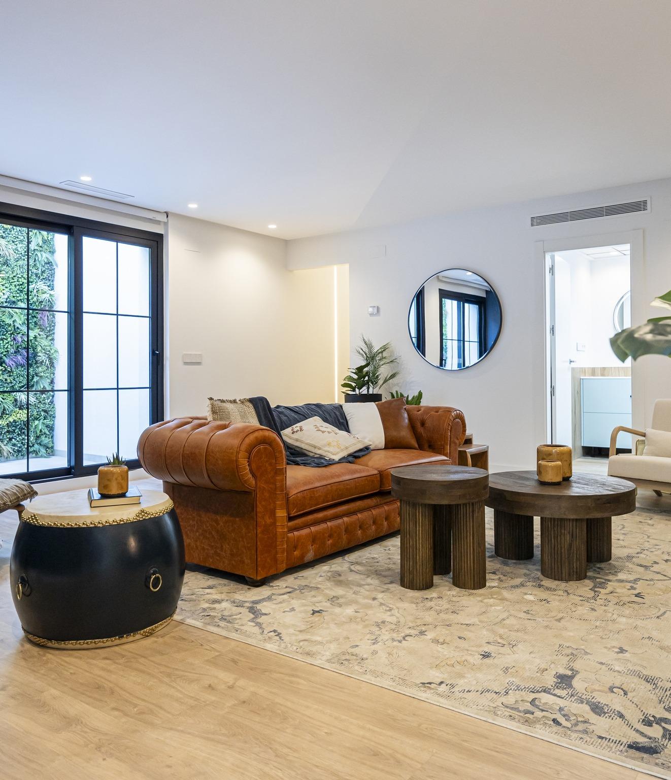 Spacious, bright living room in bespoke 3-bedroom villa in Ciudad Quesada with elegant leather sofa and modern rustic...
