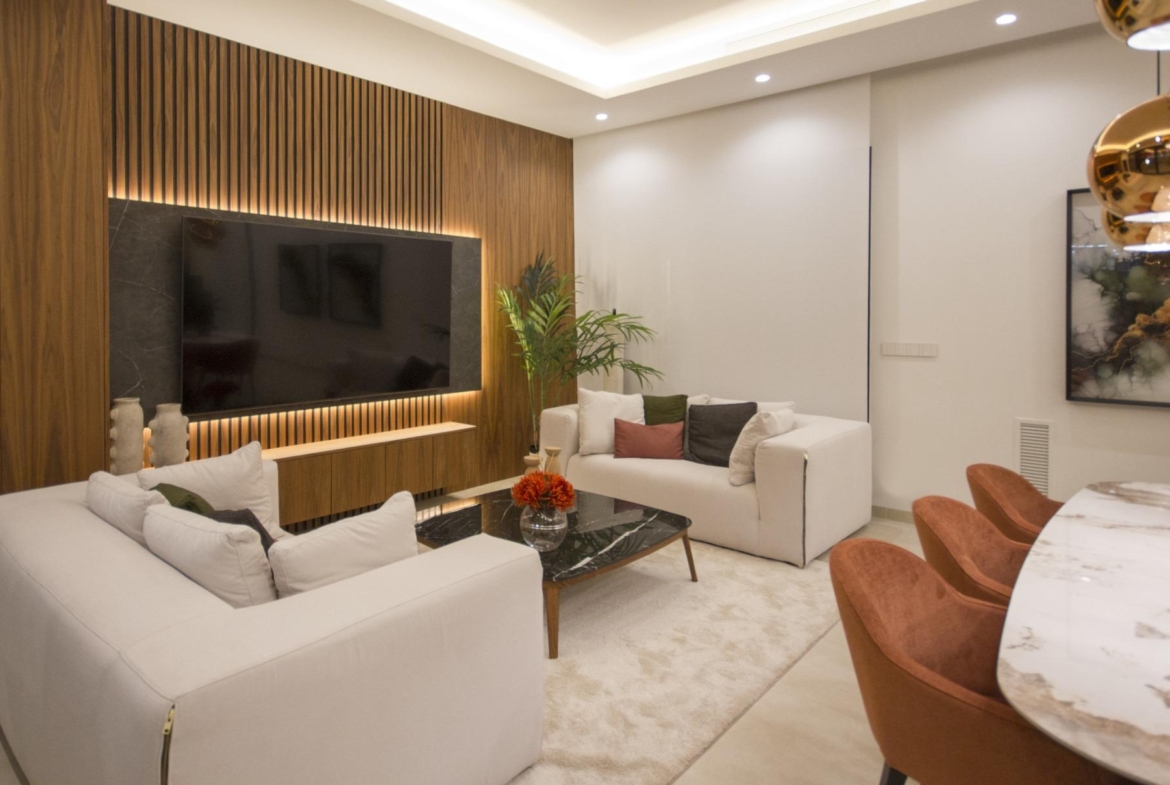 Bright modern living room in bespoke 3-bedroom villa in Ciudad Quesada with elegant wood accent wall and stylish marble...
