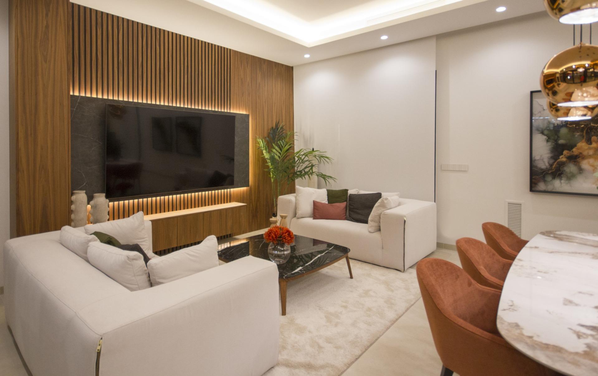 Bright modern living room in bespoke 3-bedroom villa in Ciudad Quesada with elegant wood accent wall and stylish marble...