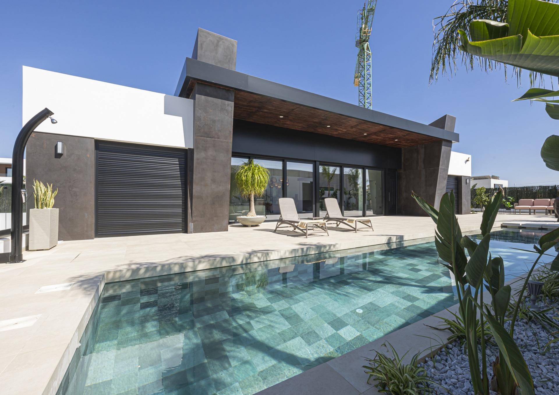 Spacious modern new build villa in Ciudad Quesada with sleek black and white facade, private pool, and sunlit terrace...