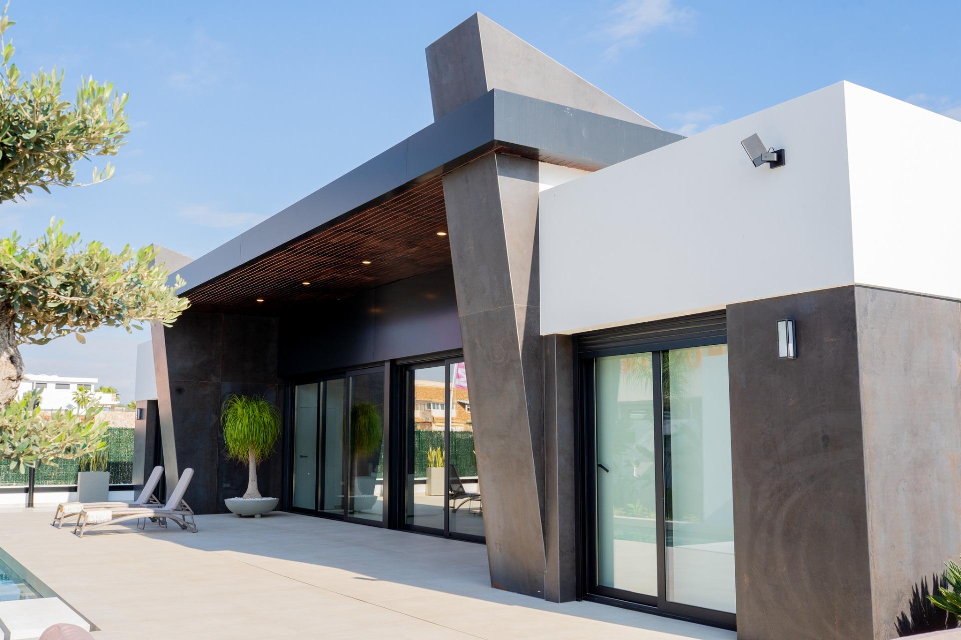 Modern bespoke 3-bedroom villa in Ciudad Quesada with sleek dark accents, floor-to-ceiling glass doors, and sun-drenched...