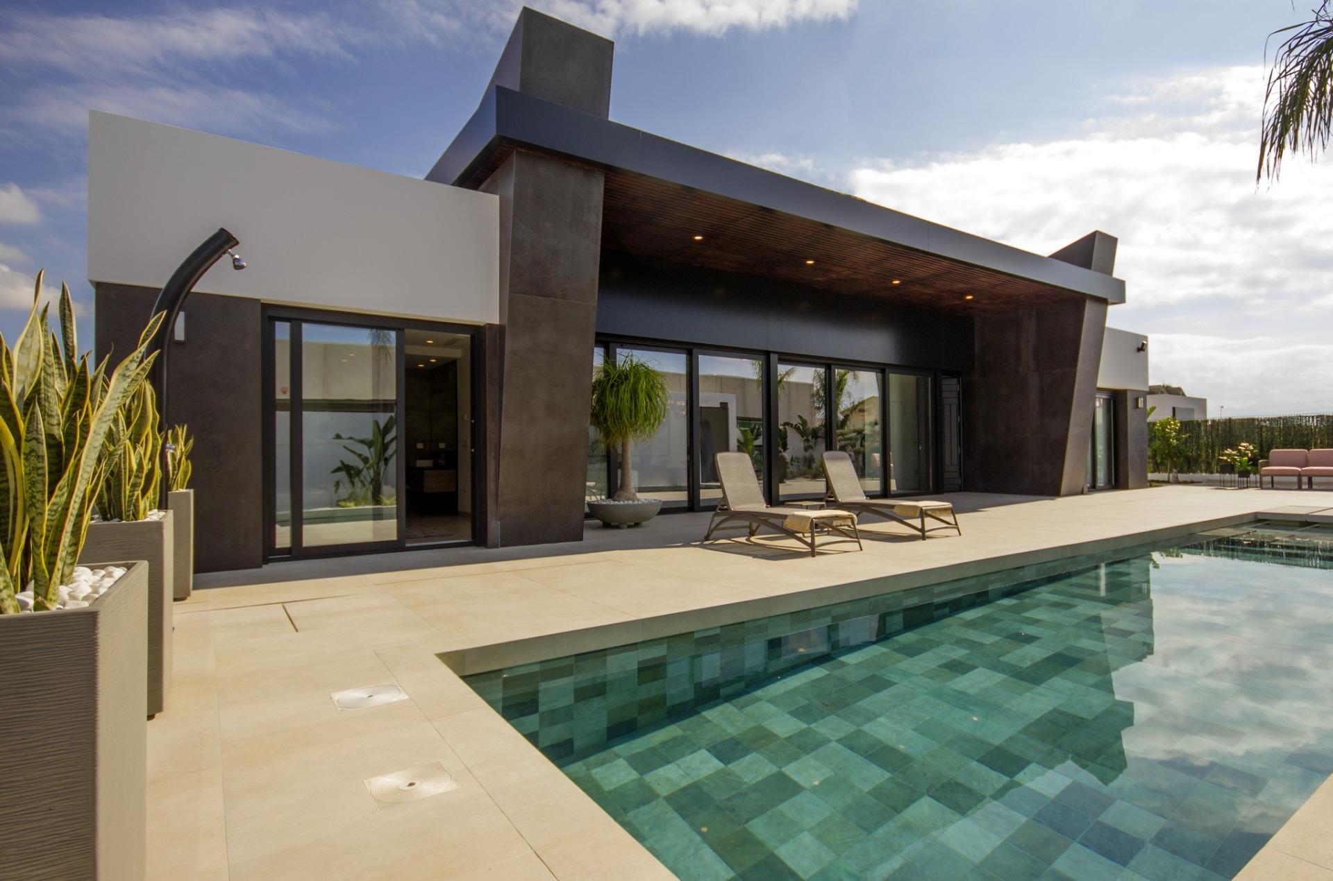 Sleek modern 3-bedroom villa in Ciudad Quesada with spacious sun-drenched terrace, private pool, and lush greenery on...