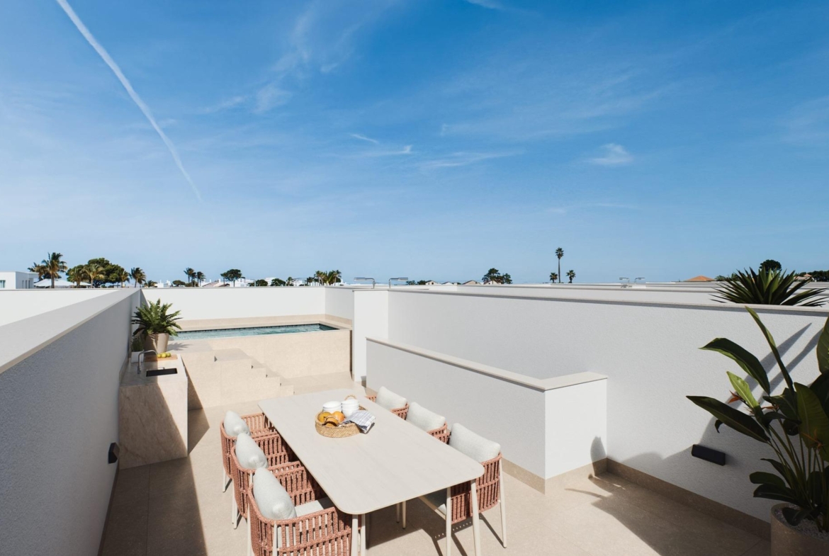 Contemporary-style-townhouses-with-private-swimming-pools-2 Raised dining table surrounded by wicker chairs with pool and steps beyond