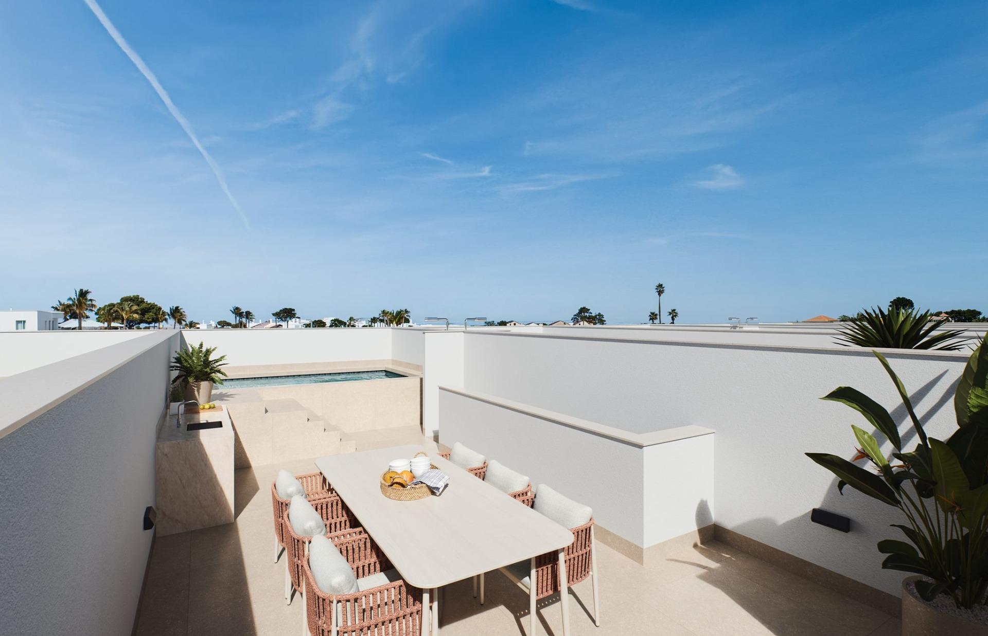 Contemporary-style-townhouses-with-private-swimming-pools-2 Raised dining table surrounded by wicker chairs with pool and steps beyond