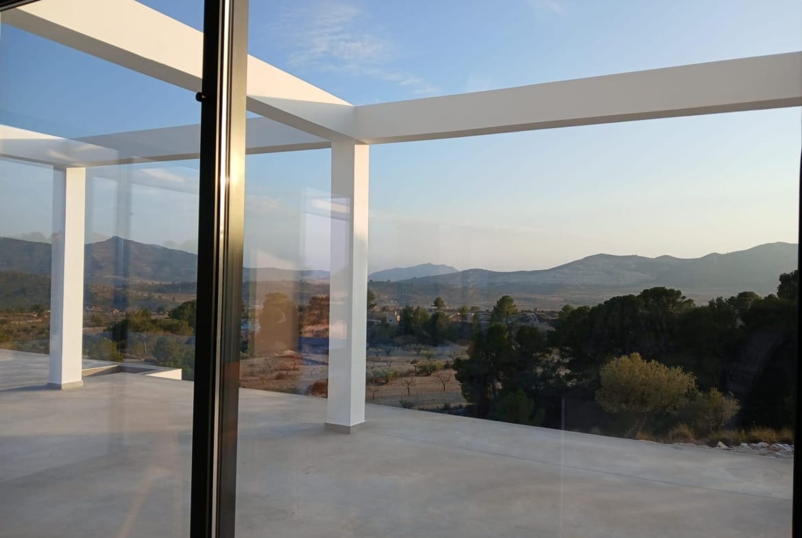 View through sliding doors towards a terrace and countryside in Pinoso, Alicante