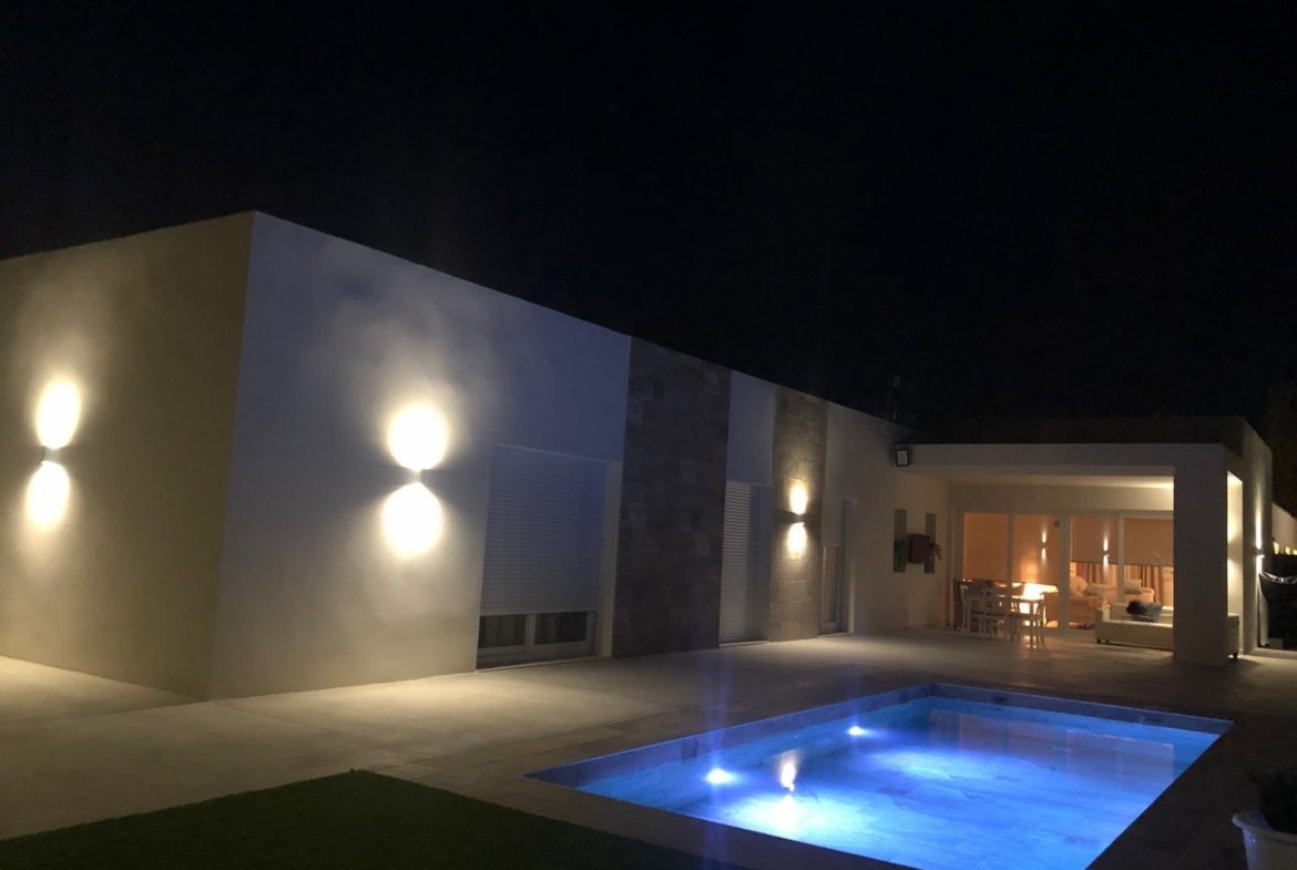 Night view across the private pool towards a Pinoso country villa