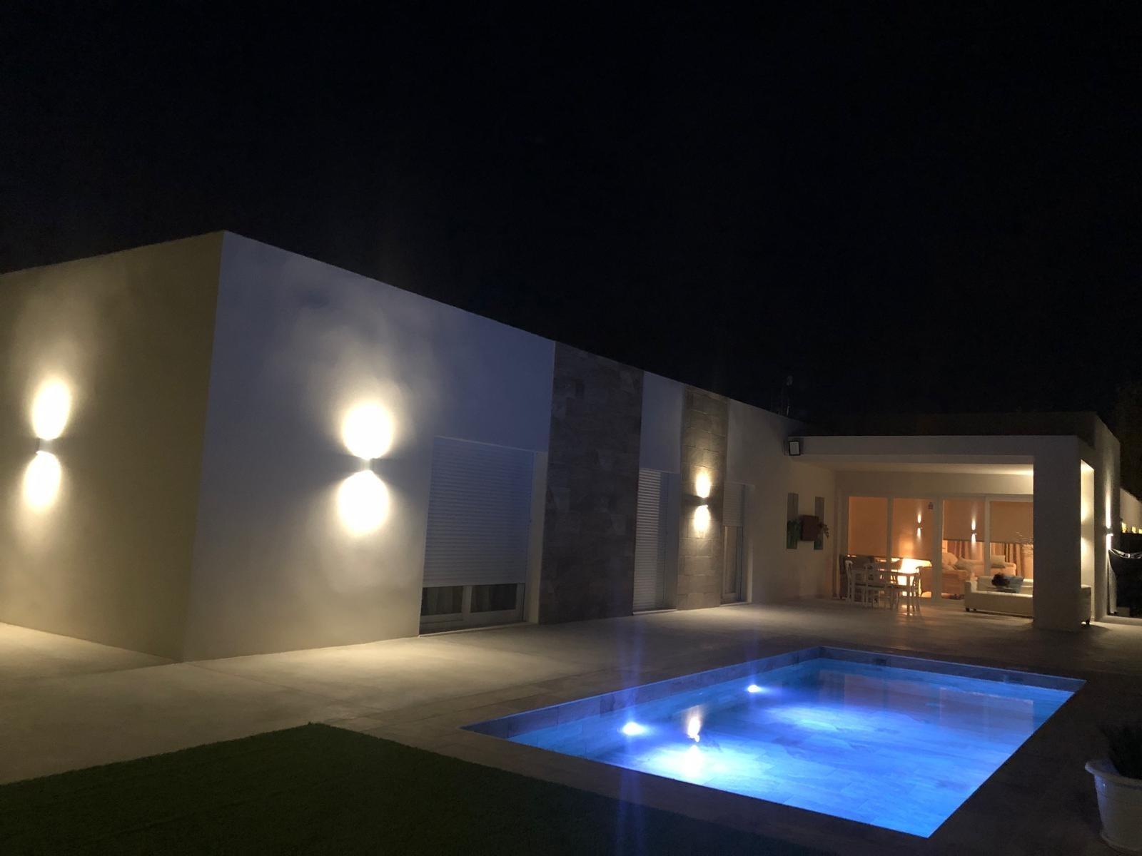 Night view across the private pool towards a Pinoso country villa