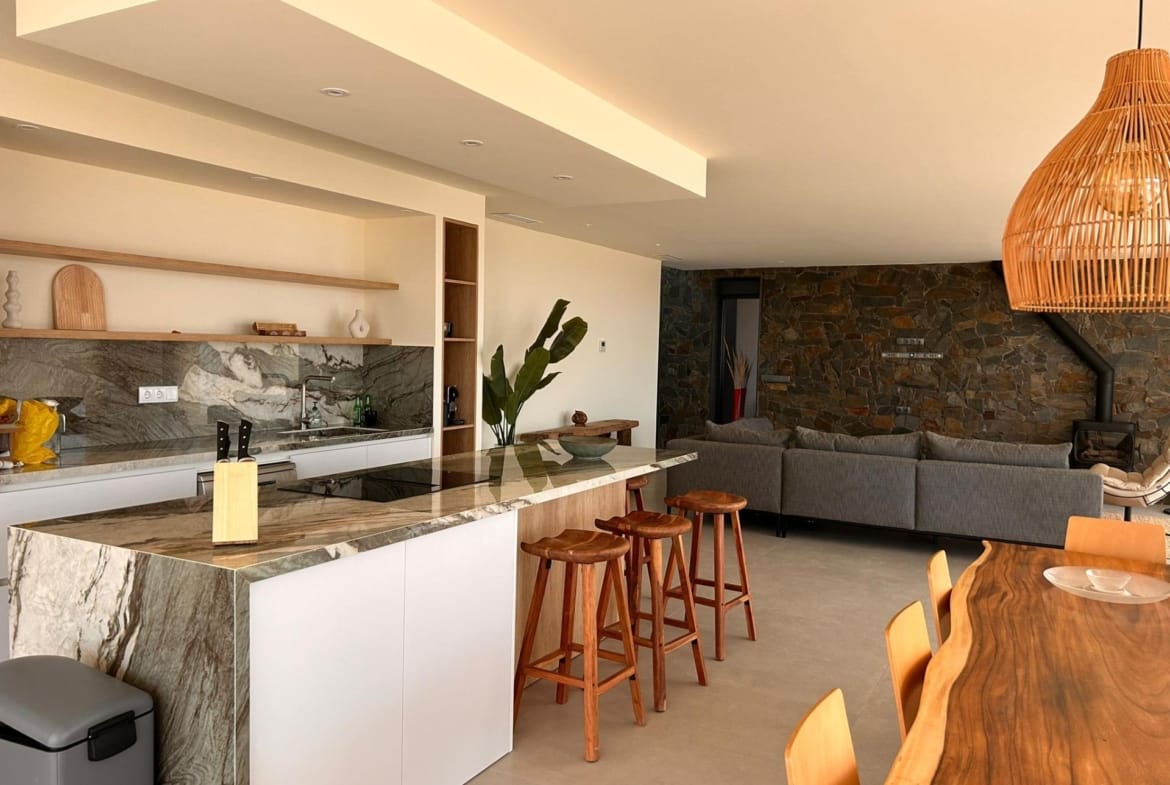 Open kitchen with breakfast bar and adjoining living area in Pinoso, Alicante