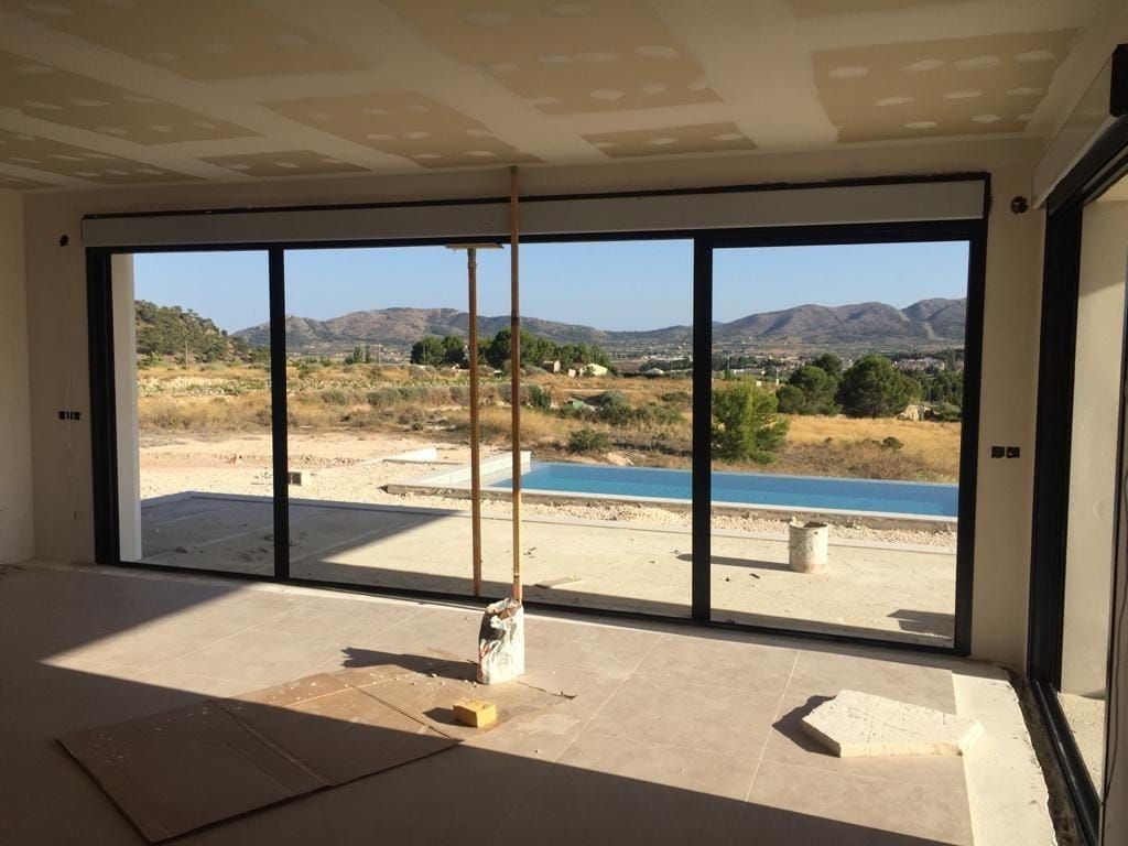 Living room under construction with pool view in Pinoso, Alicante
