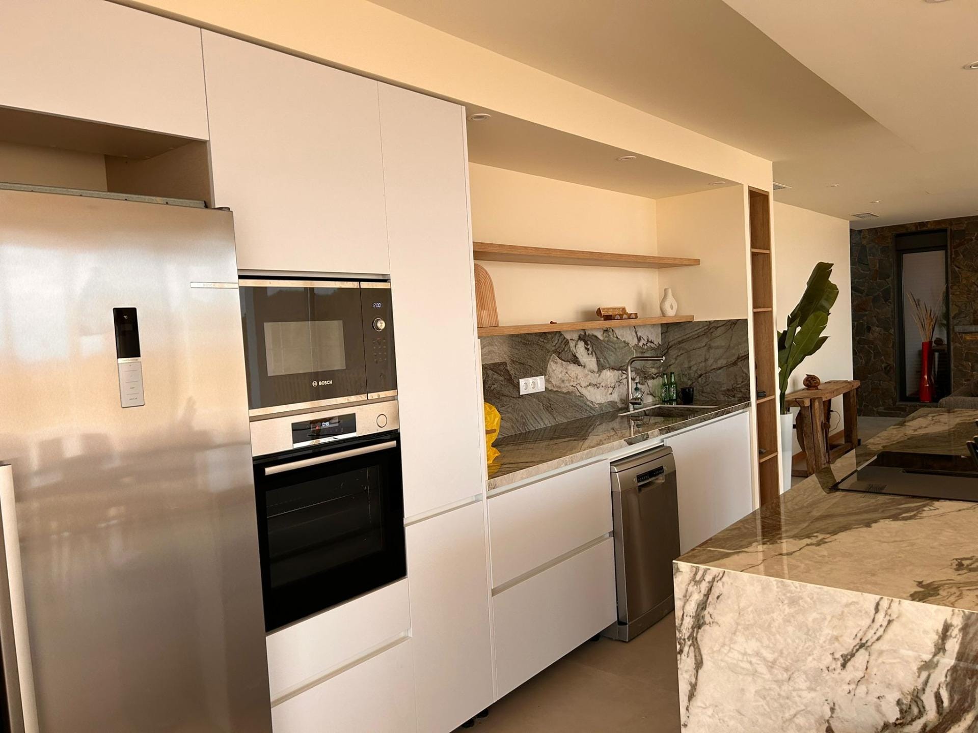Custom-Built-New-Villas-in-Pinoso-Alicante-Spacious-Homes-in-Natural-Surroundings-21 Kitchen appliances and shelving beside an island worktop in Pinoso, Alicante