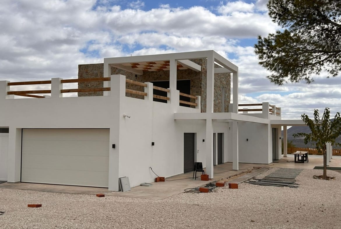 Closed garage and villa entrance beneath an upper terrace in Pinoso, Alicante