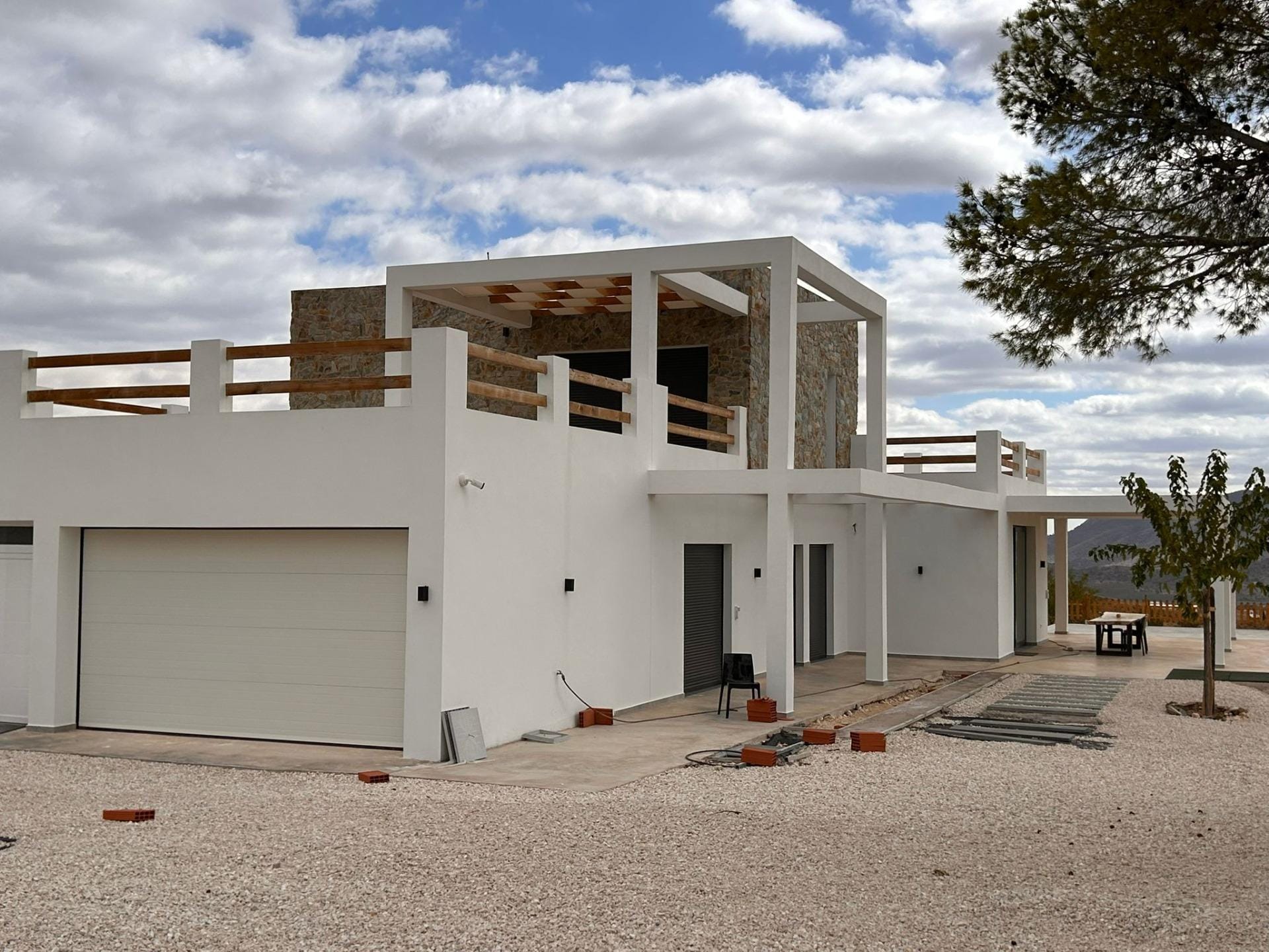 Custom-Built-New-Villas-in-Pinoso-Alicante-Spacious-Homes-in-Natural-Surroundings-3 Closed garage and villa entrance beneath an upper terrace in Pinoso, Alicante