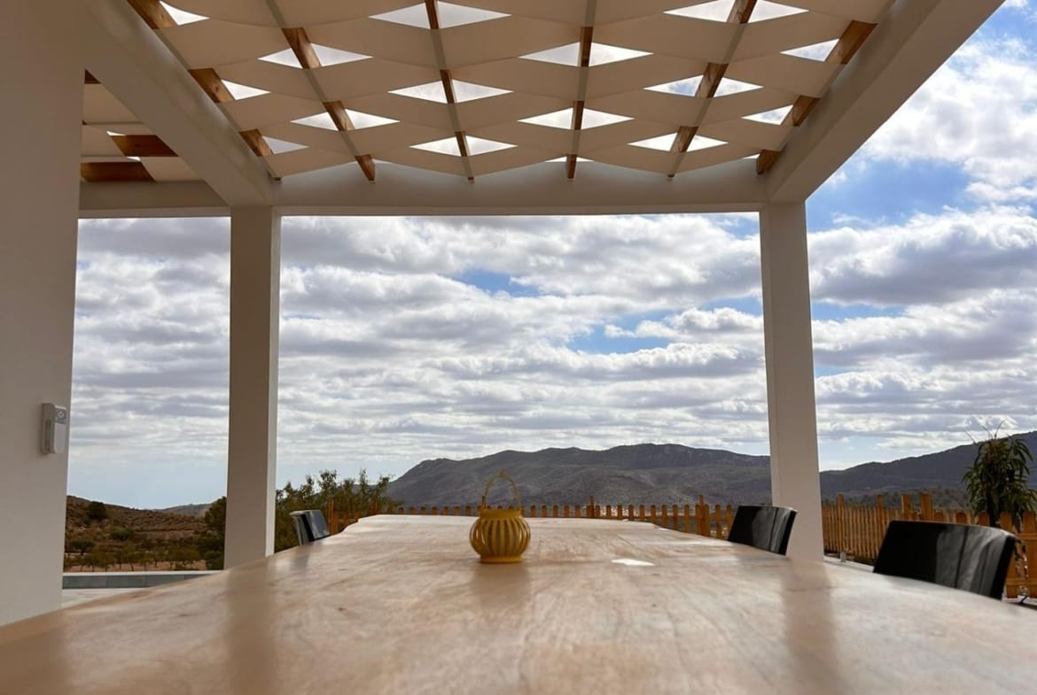 Outdoor dining table under terrace shade panels in Pinoso, Alicante