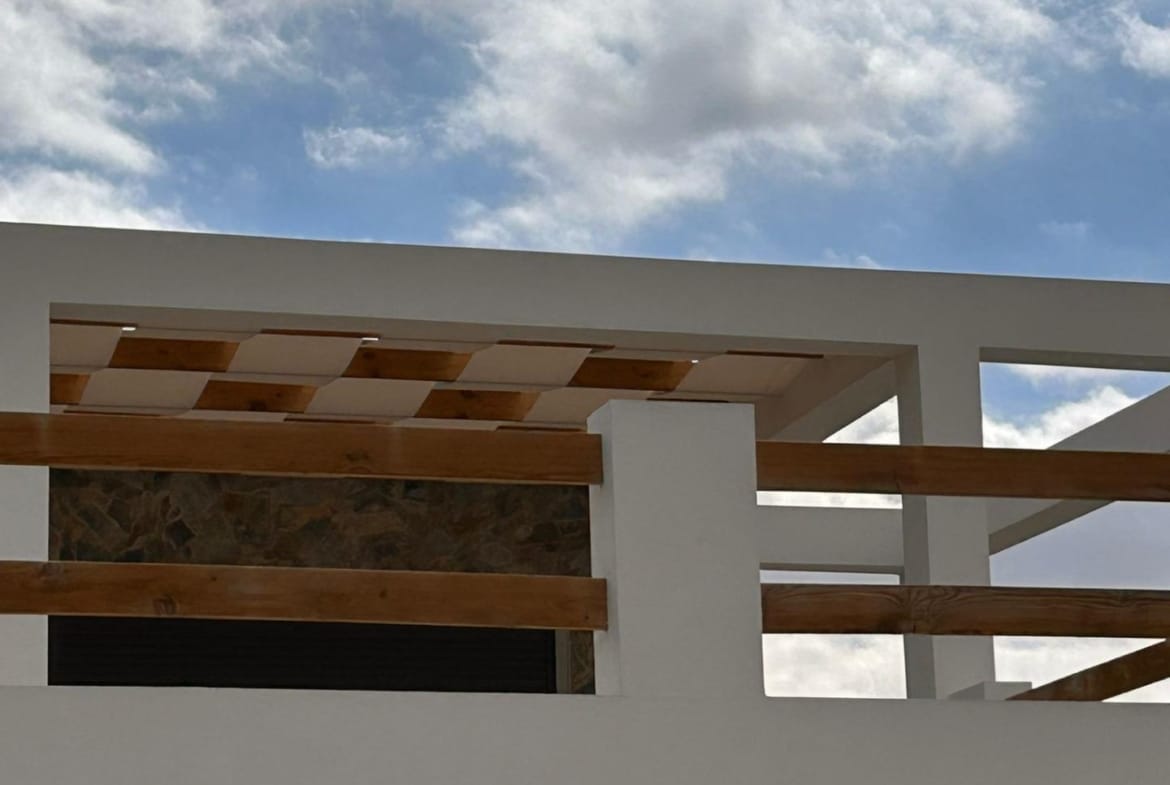 Upper terrace railing beneath a cloudy sky in Pinoso, Alicante