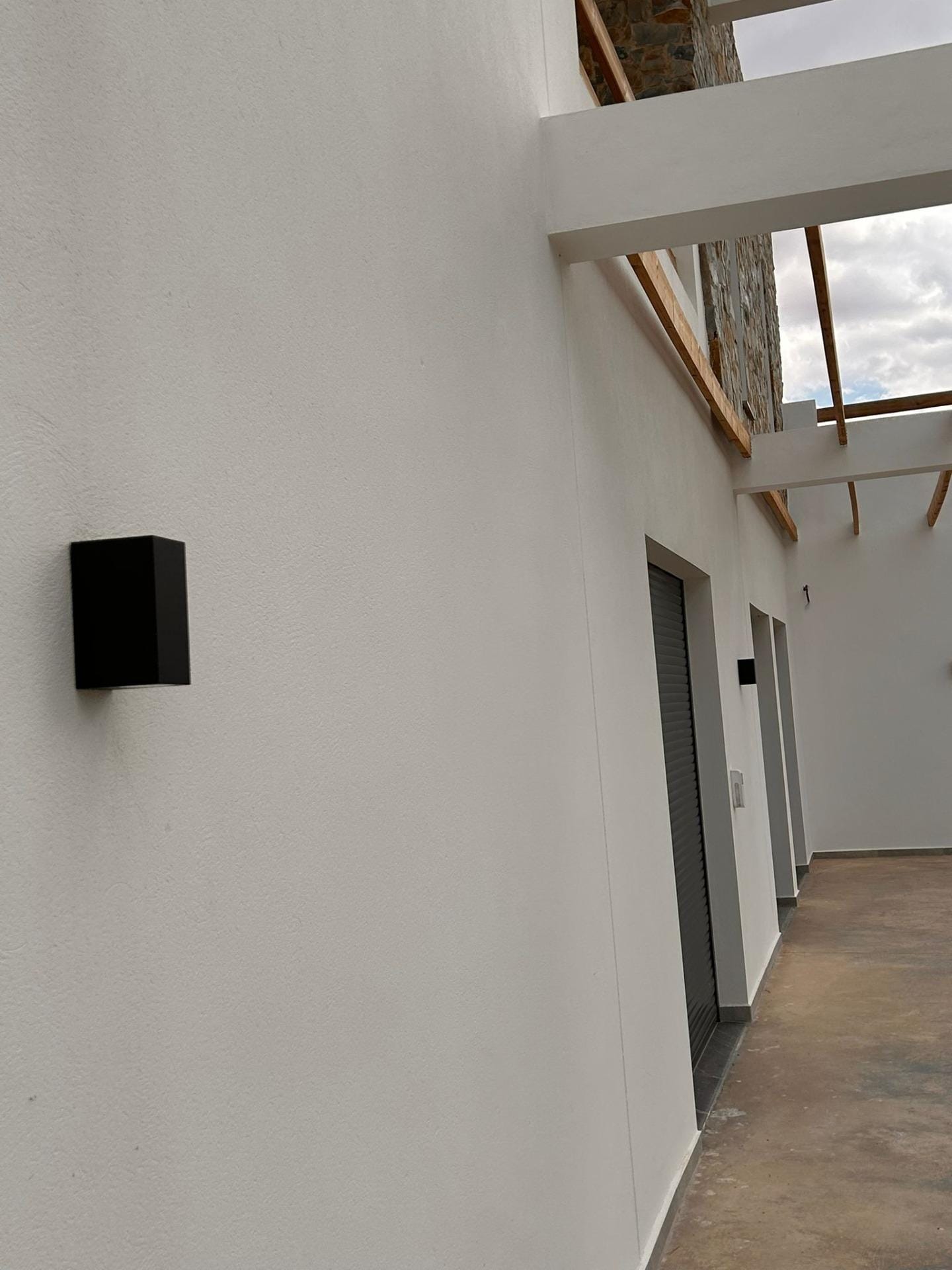 Custom-Built-New-Villas-in-Pinoso-Alicante-Spacious-Homes-in-Natural-Surroundings-36 Exterior wall light and sheltered walkway beside the villa in Pinoso, Alicante