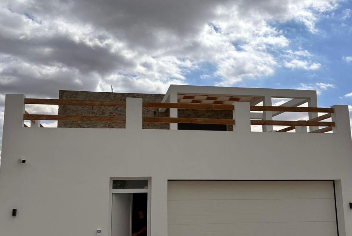 Villa entrance and closed garage below an upper terrace in Pinoso, Alicante