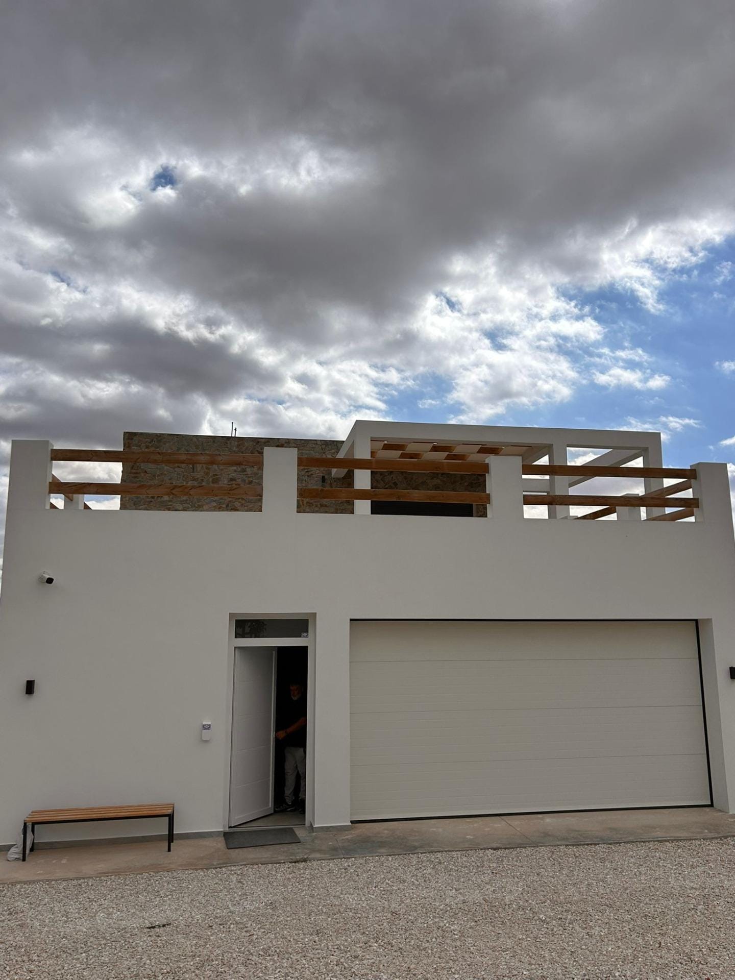 Custom-Built-New-Villas-in-Pinoso-Alicante-Spacious-Homes-in-Natural-Surroundings-38 Villa entrance and closed garage below an upper terrace in Pinoso, Alicante