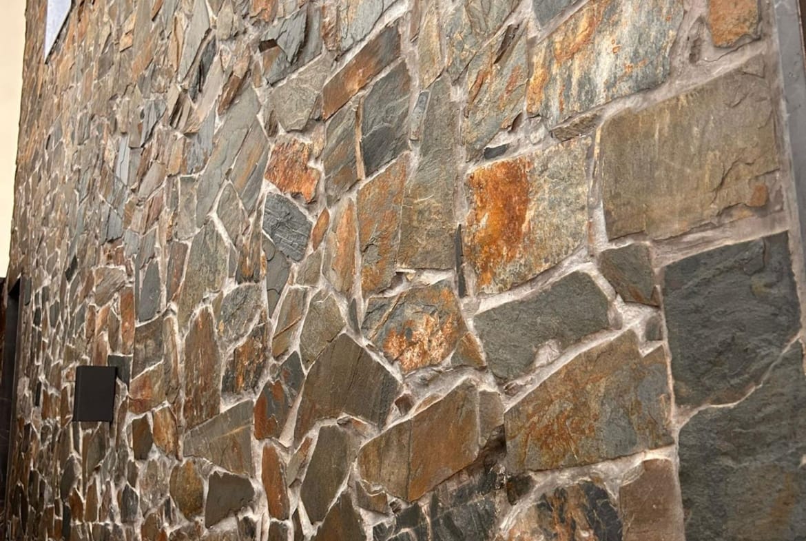 Natural stone-clad wall beside the villa in Pinoso, Alicante