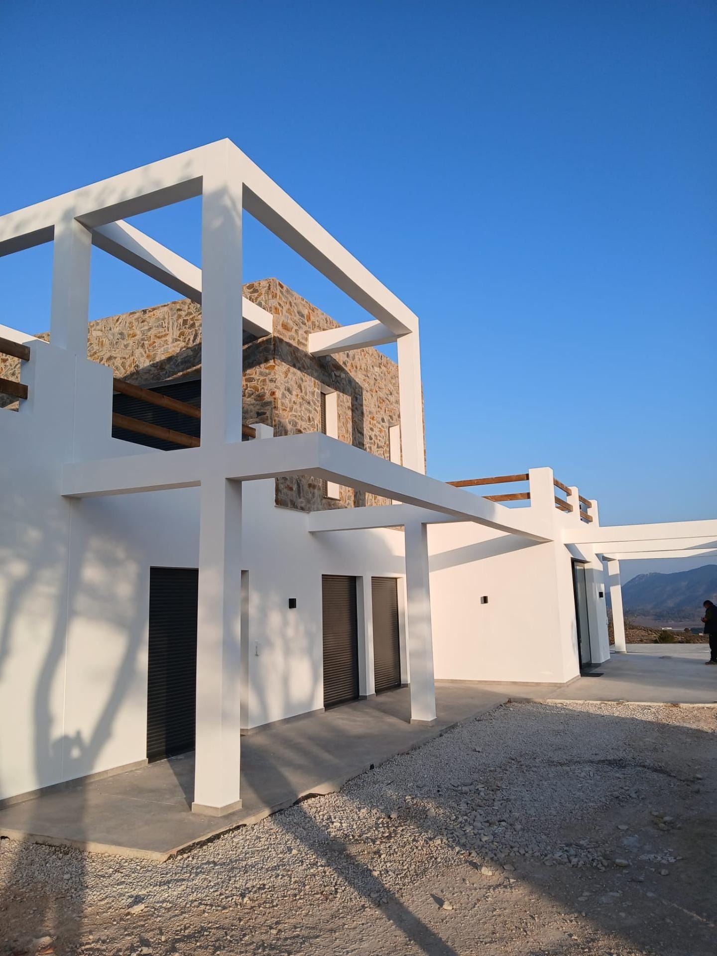 Custom-Built-New-Villas-in-Pinoso-Alicante-Spacious-Homes-in-Natural-Surroundings-44 Two-storey villa facade with terrace beams and stone cladding in Pinoso, Alicante
