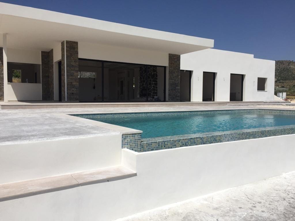 Private pool and paved terrace beside a villa in Pinoso, Alicante