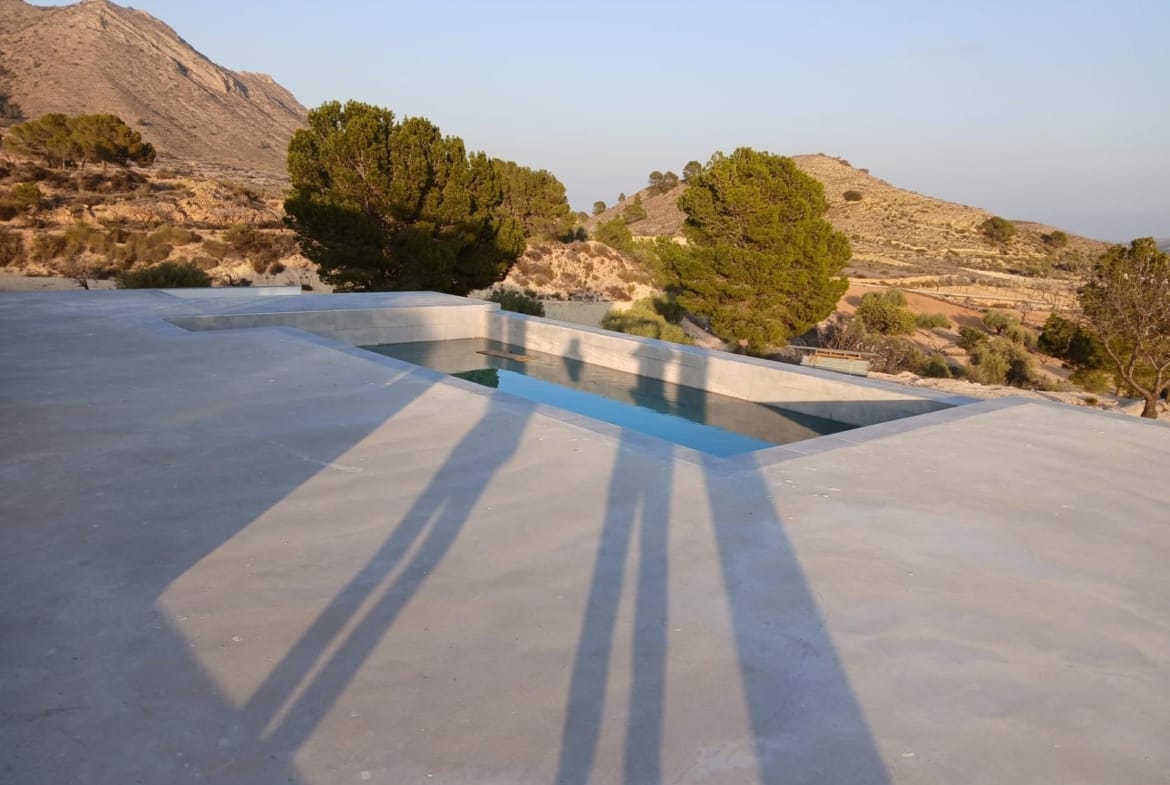 Private pool and paved terrace with surrounding hills in Pinoso, Alicante